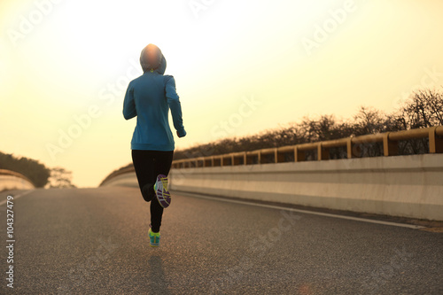 young fitness woman trail runner running  on city road