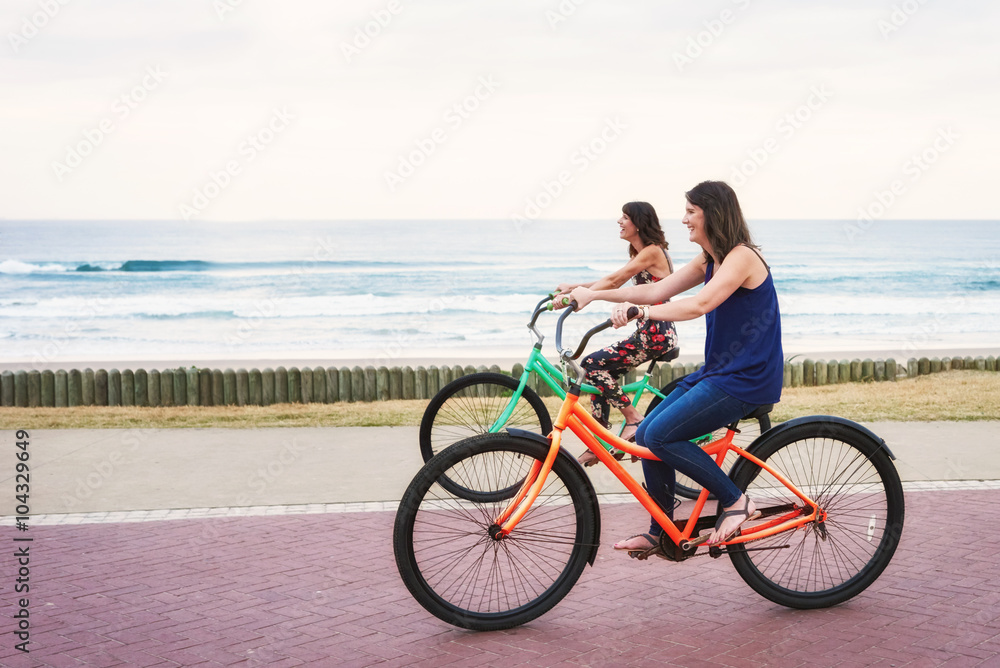 Sisters riding bicycles beside each other
