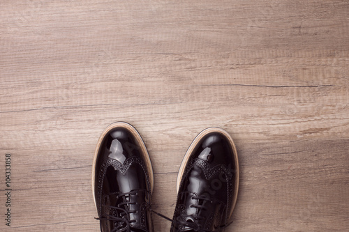 New pair of brogues shoes on a wooden background