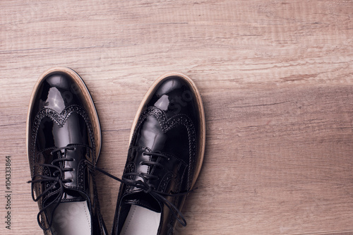 New pair of brogues shoes on a wooden background