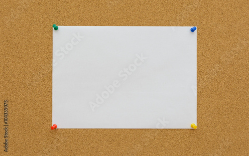 White paper on cork board