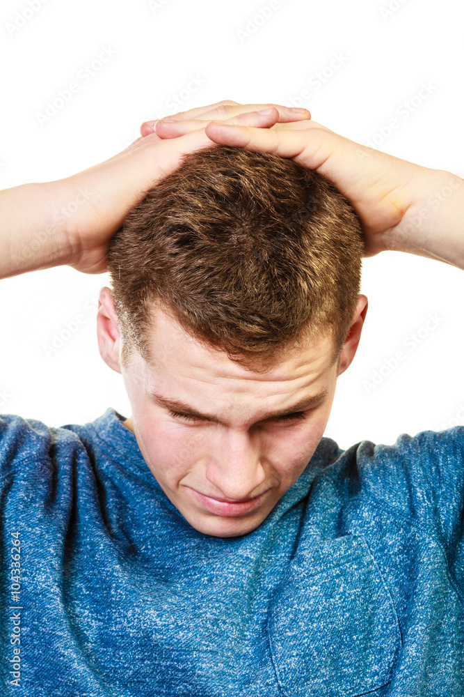 Closeup stressed man holds head with hands Closeup stressed man holds head with hands