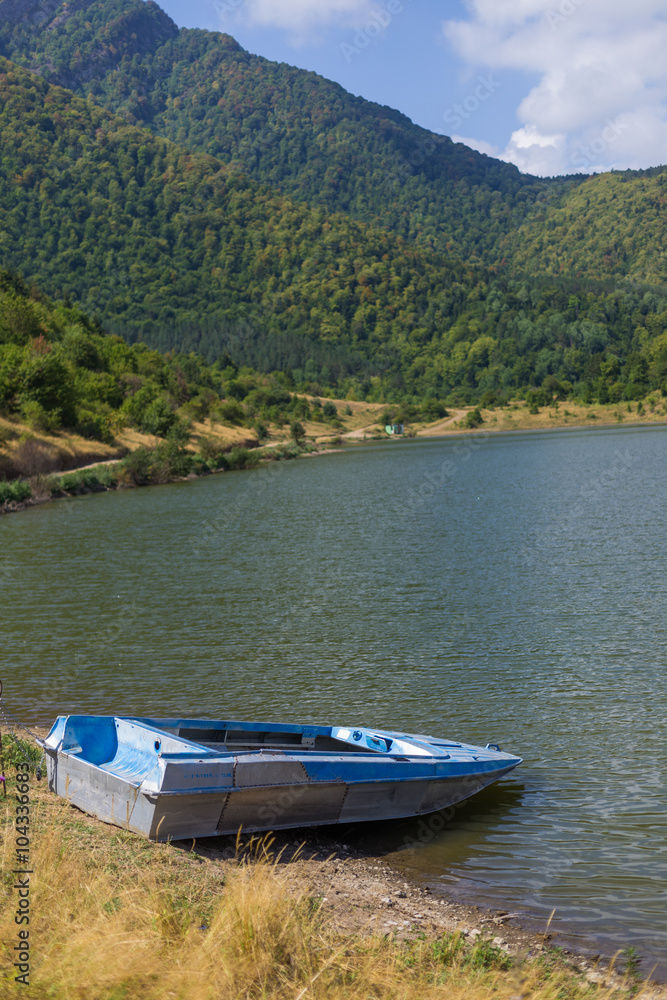 lake with boat at mountains