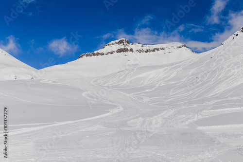 Snowy mountains with ski tracers © grycikua