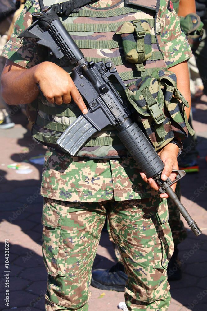 Military personnel with assault rifle