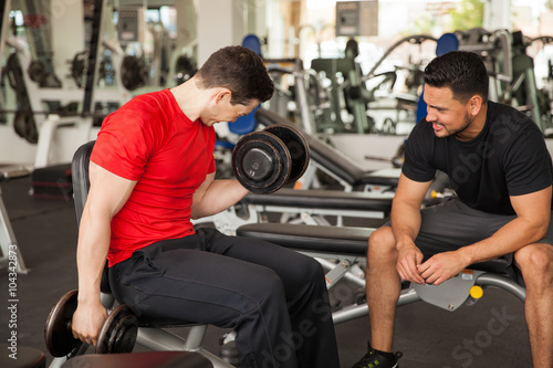 Personal trainer encouraging a young man