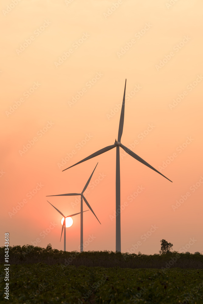 Fototapeta premium silhouette of wind turbines at sunset
