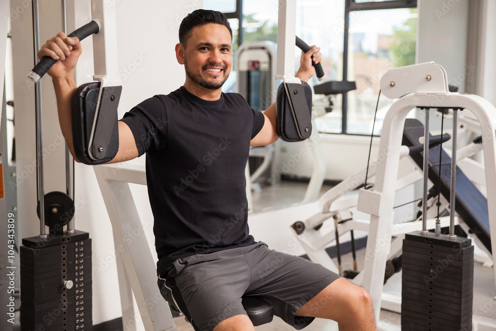 Hispanic young man working out at a gym Hispanic young man working out at a gym