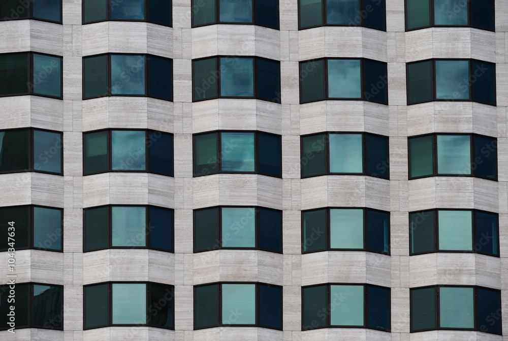 close up on facade view of glass windows in office building close up on facade view of glass windows in office building