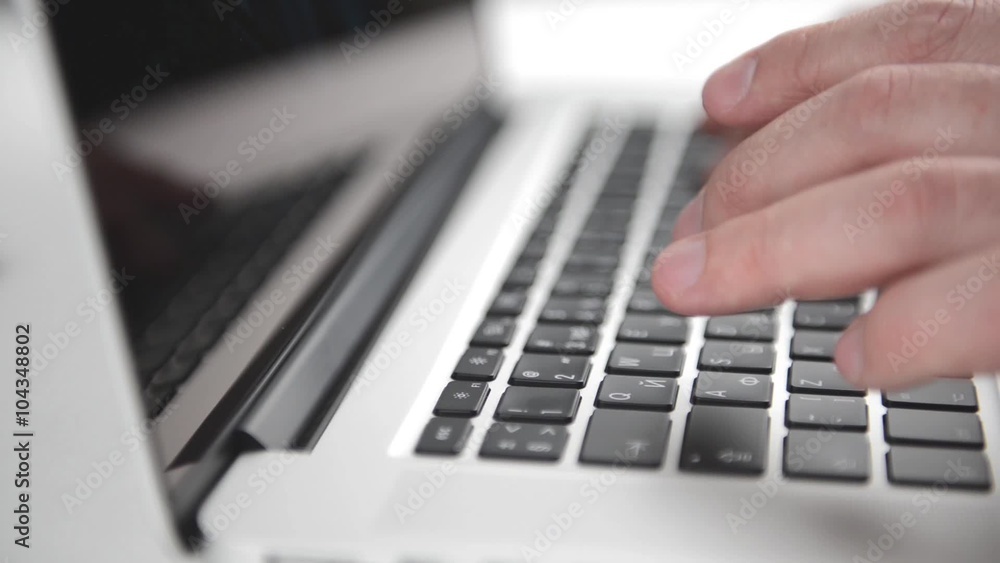 Man's hands typing on the black laptop keyboard. Close view Full HD video Man's hands typing on the black laptop keyboard. Close view Full HD video