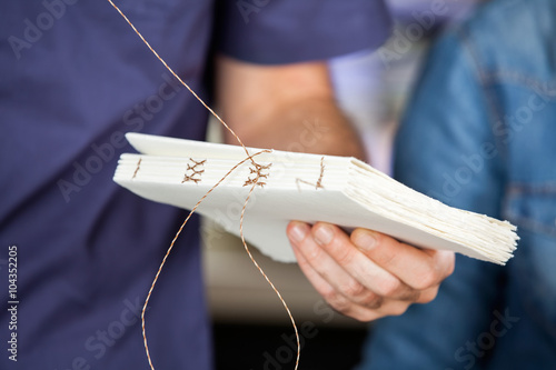 Male Worker Binding Pages In Paper Factory