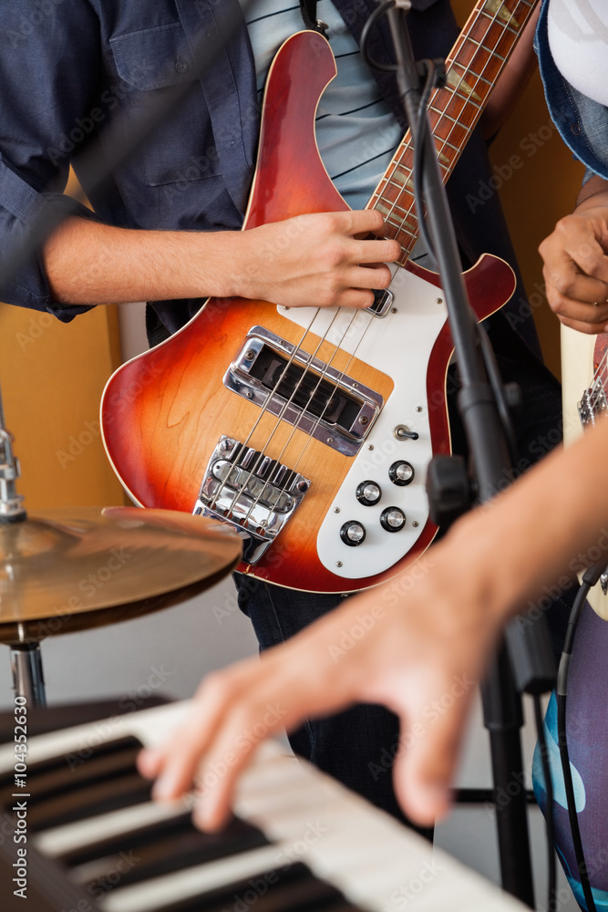 Band Member Playing Guitar In Recording Studio Band Member Playing Guitar In Recording Studio