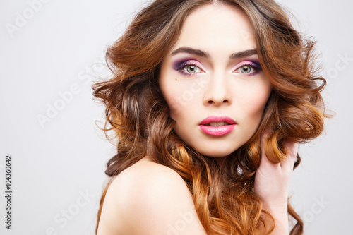 Close-up portrait of beautiful young woman with perfect make-up and hair-style