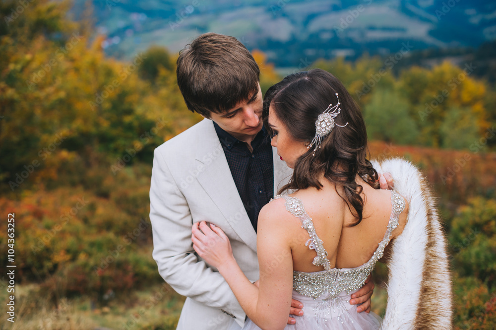 happy newly married couple posing in the mountains happy newly married couple posing in the mountains