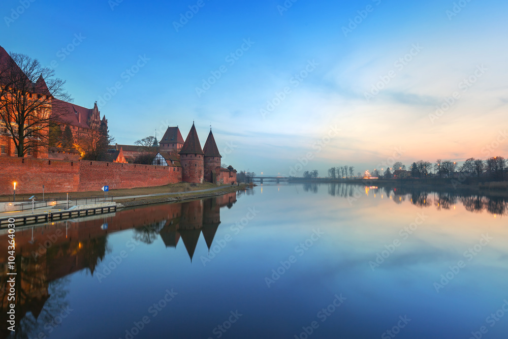 The Castle of the Teutonic Order in Malbork at dusk, Poland