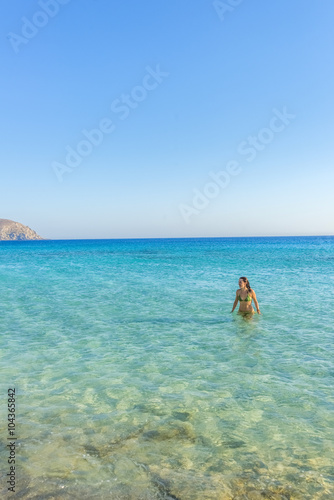 Girl walking in the water, on one of the most beautiful beaches