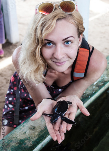 Woman hold in hand a turtle, Sri-Lanka