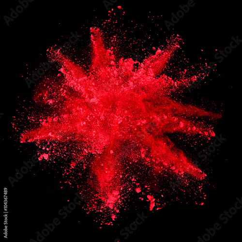 Fototapeta Explosion of red powder on black background