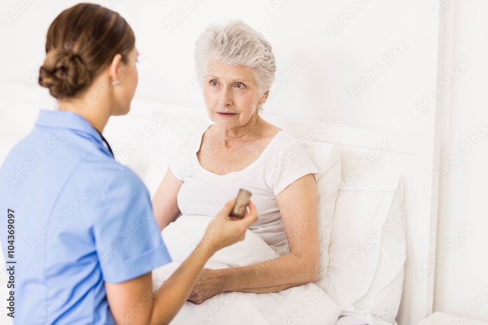 Nurse taking care of suffering senior patient Nurse taking care of suffering senior patient