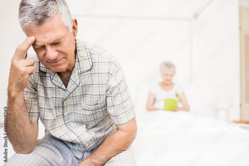 Suffering senior man touching his forehead Suffering senior man touching his forehead