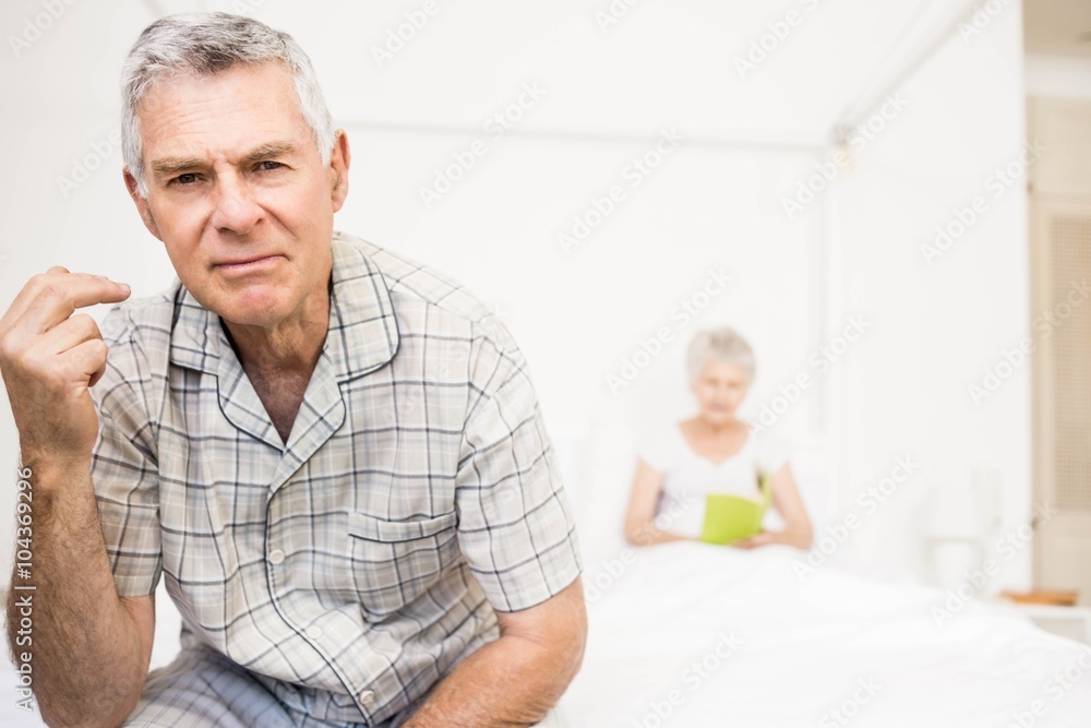 Suffering senior man touching his forehead Suffering senior man touching his forehead