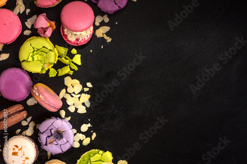 Assorted colorful macaroons on a dark background