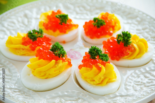 Eggs stuffed with creamy mousse and red caviar.