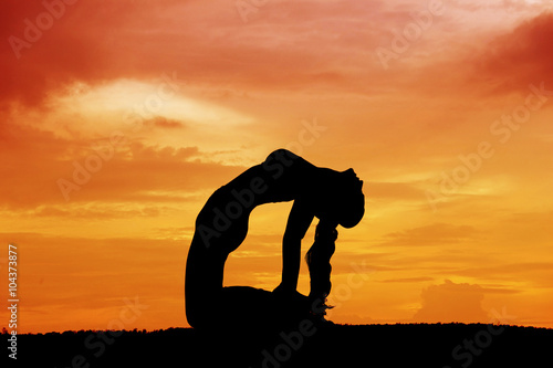 Silhouette of a beautiful Yoga woman
