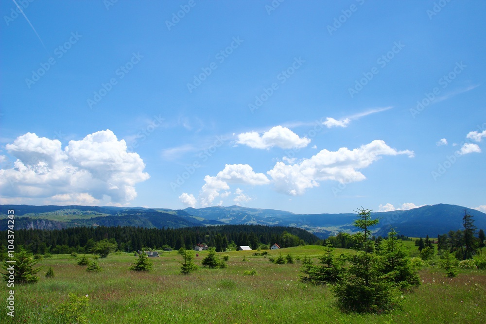 Beautiful mountain landscape with nice clouds on blue sky