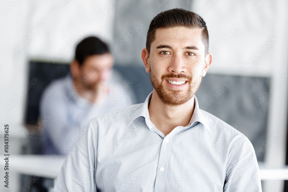 Attractive office worker sitting at desk Attractive office worker sitting at desk