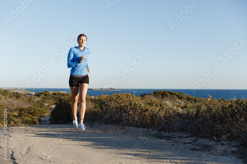 Sport runner jogging on beach working out © Sergey Nivens