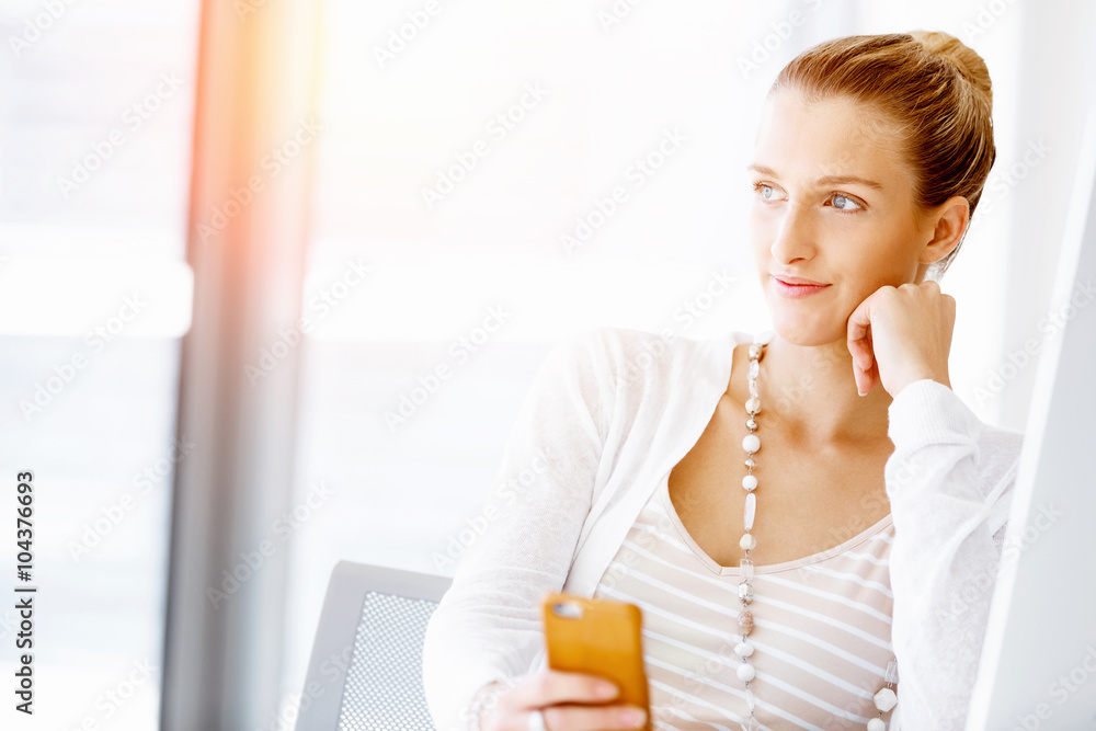 Attractive office worker sitting at desk
