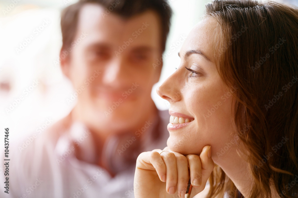 Young pretty woman smiling with man on background Young pretty woman smiling with man on background