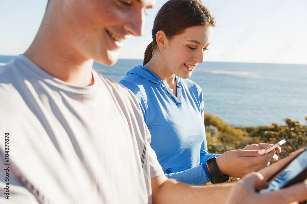 Young couple with smartphones outdoors Young couple with smartphones outdoors