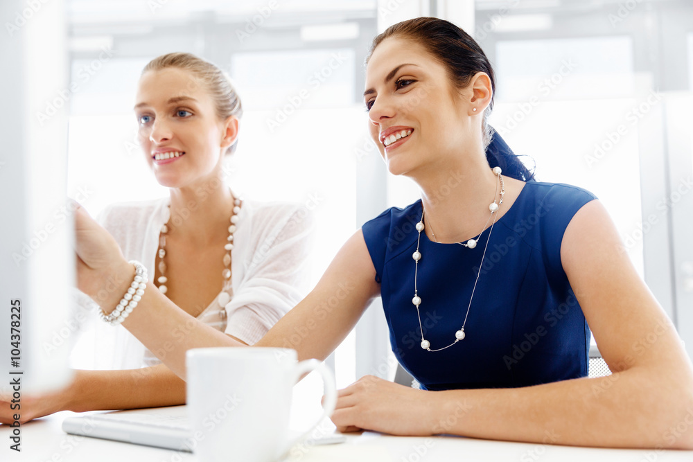 Two female colleagues in office Two female colleagues in office