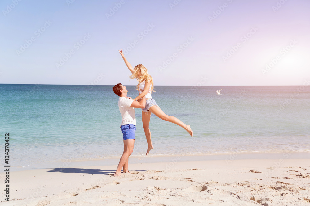 Happy couple jumping on beach vacations Happy couple jumping on beach vacations