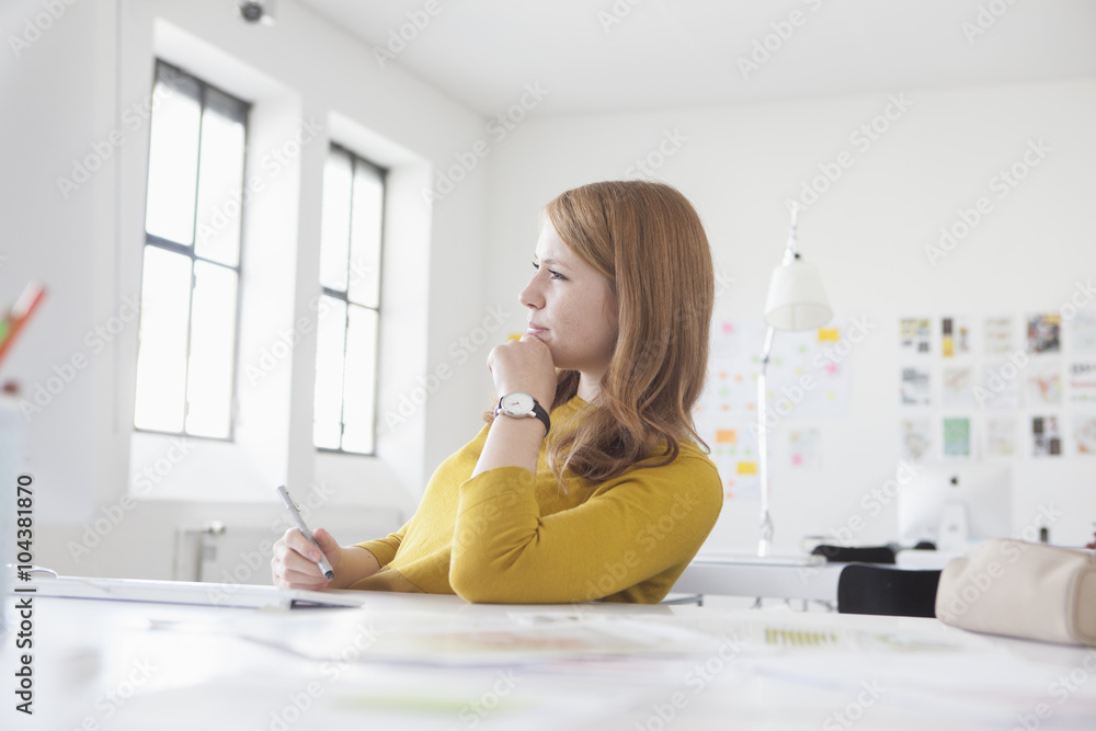 Young woman in office working at desk Young woman in office working at desk
