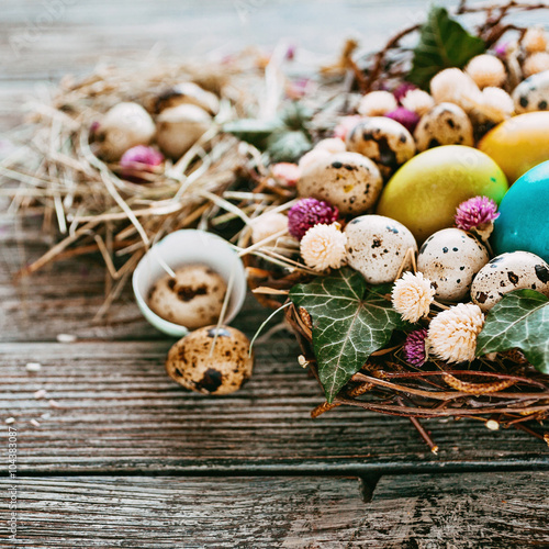 Easter composition of Easter eggs in the nest on the old wooden background. Retro vintage style. Soft focus 