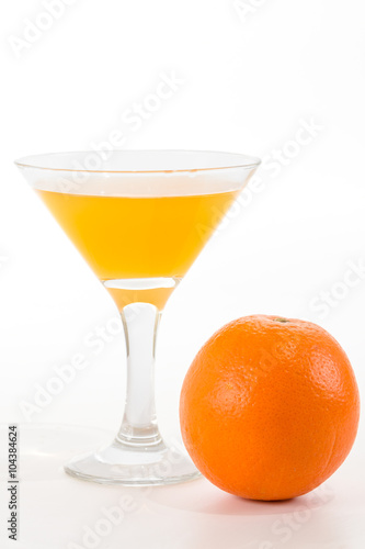 orange juice in a glass and orange on a white background