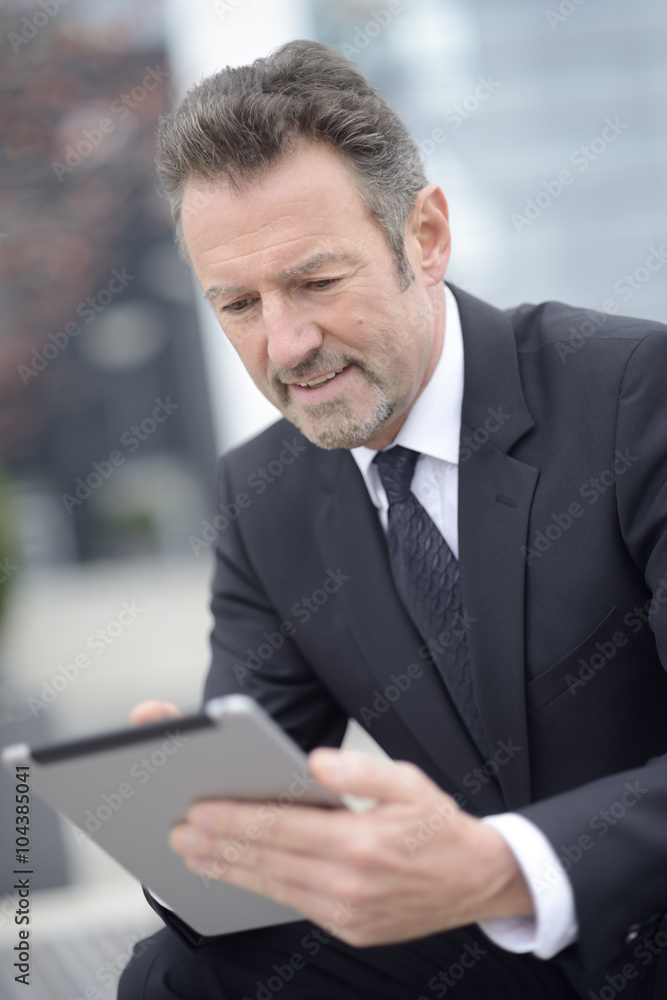 Young businessman using digital tablet Young businessman using digital tablet