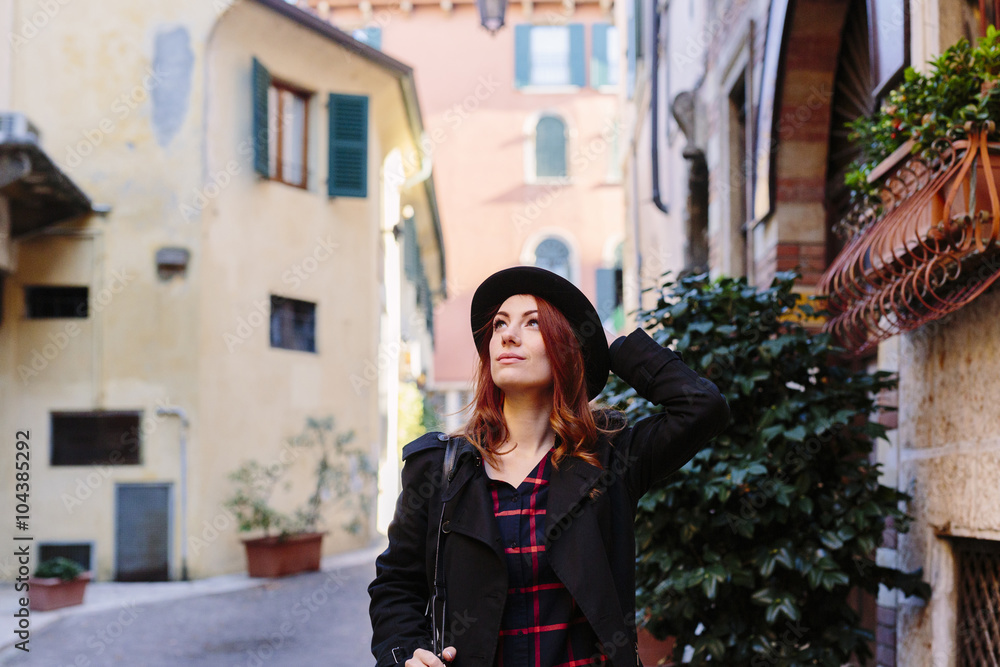 Italy, Verona, young woman in the city looking around Italy, Verona, young woman in the city looking around