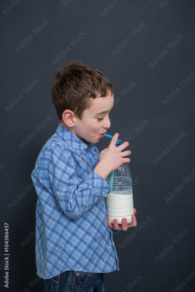 Cheerful smiling boy drinking milk
Cheerful smiling boy drinking milk