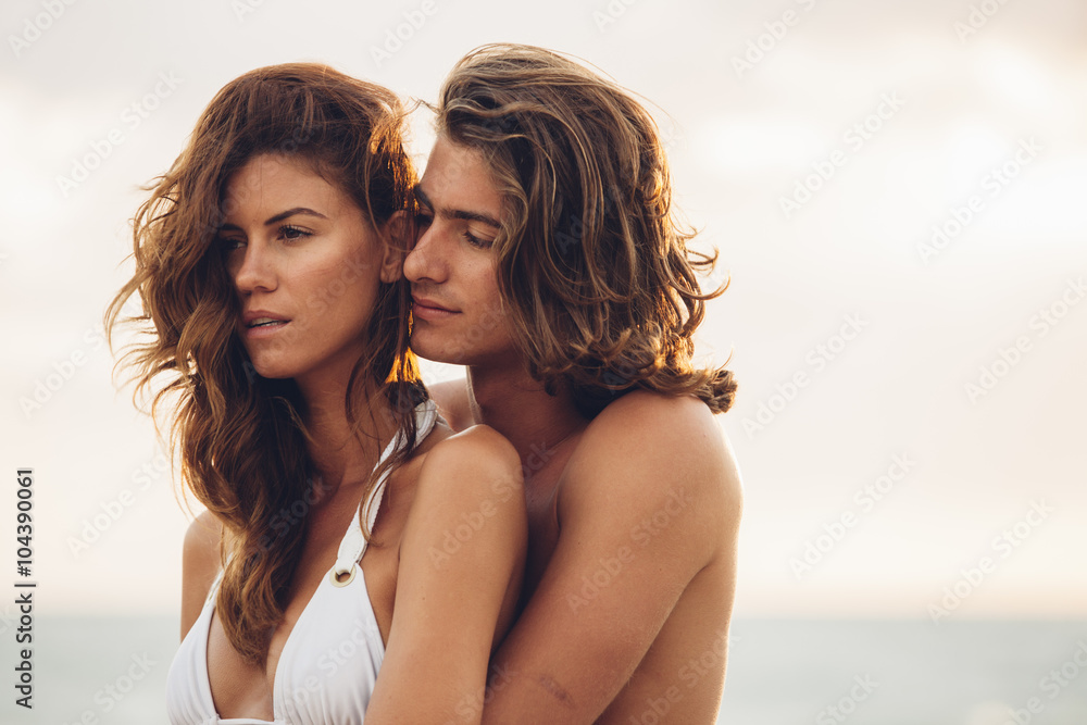 Romantic young couple embracing each other on the beach Romantic young couple embracing each other on the beach