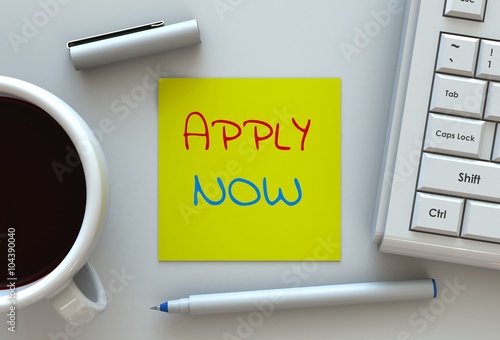APPLY NOW, message on note paper, computer and coffee on table