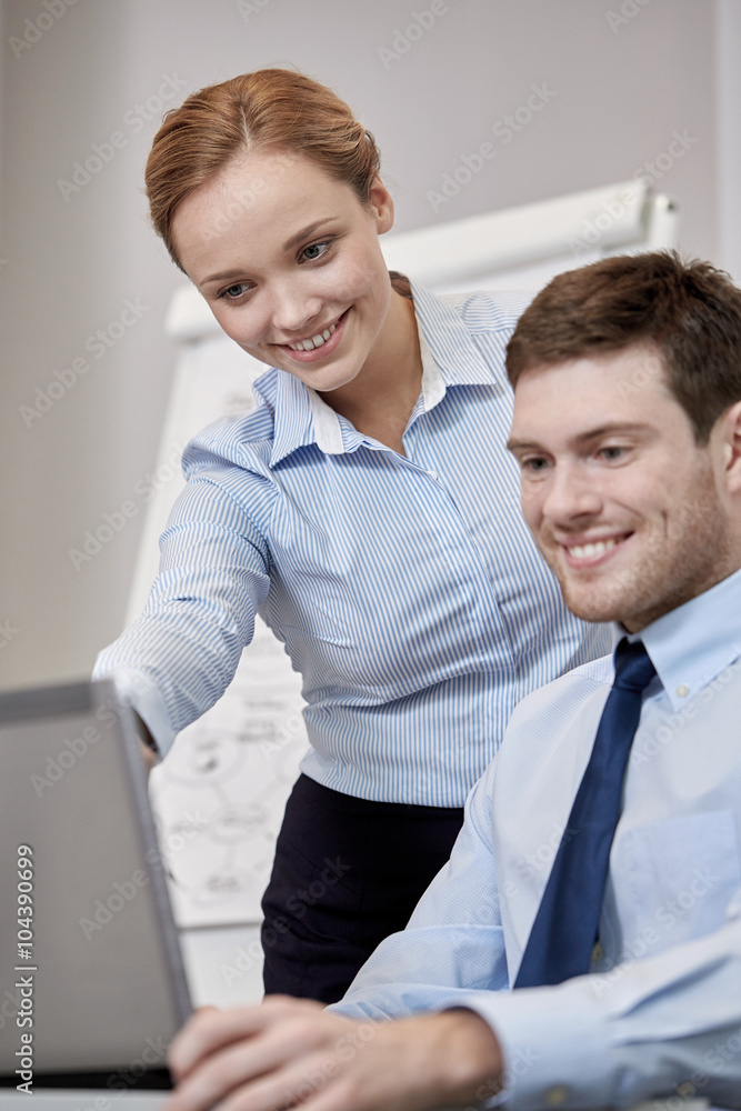 smiling businesspeople with laptop in office smiling businesspeople with laptop in office