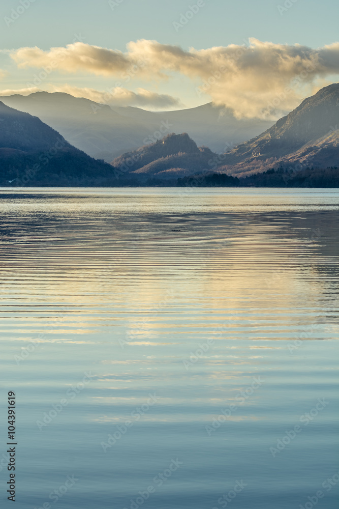 Perfectly calm morning at Derwentwater in the English Lake District with ripples in the water and clouds in sky.