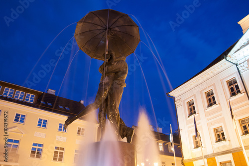 Statue of kissing students under umbrella  photo