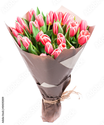 Fototapeta Naklejka Na Ścianę i Meble -  bouquet of pink tulips in a package of kraft paper, isolated on