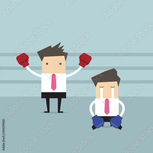 Businessman wearing boxing gloves standing in boxing ring as winner and defeated opponent kneel on floor.