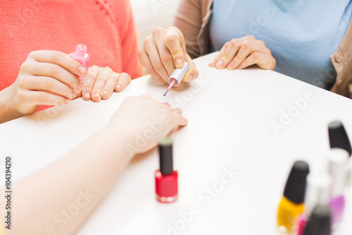 close up of young women with nail polish